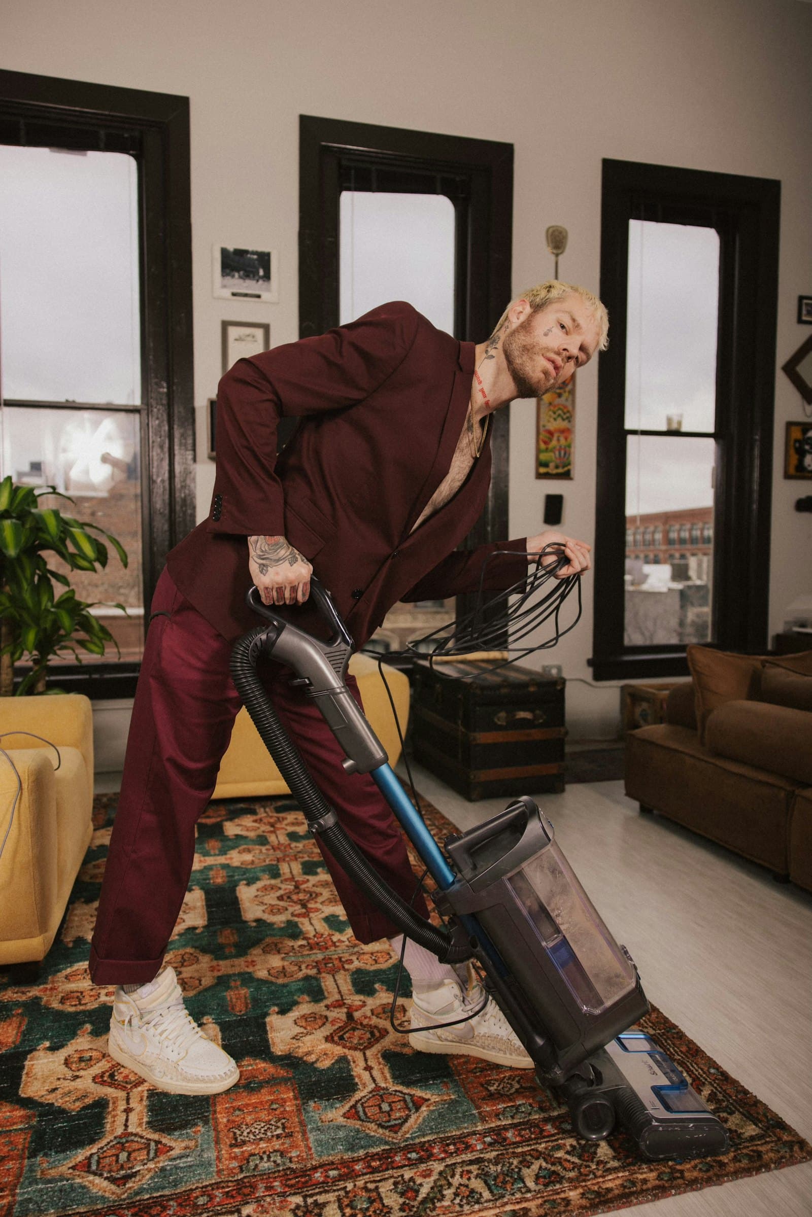 Cleaner vacuuming carpet in a hotel lobby