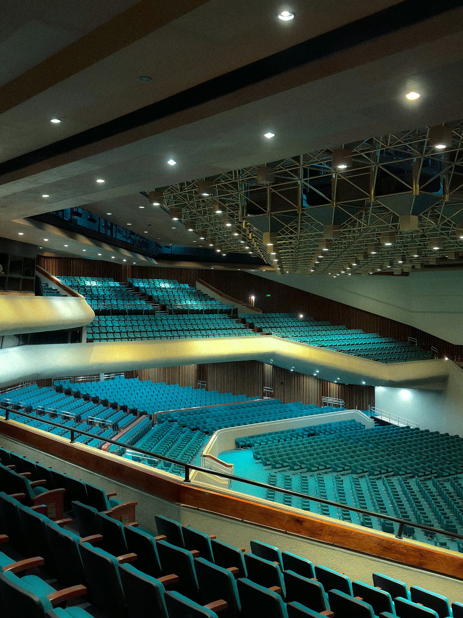 Large empty arena with rows of teal seats