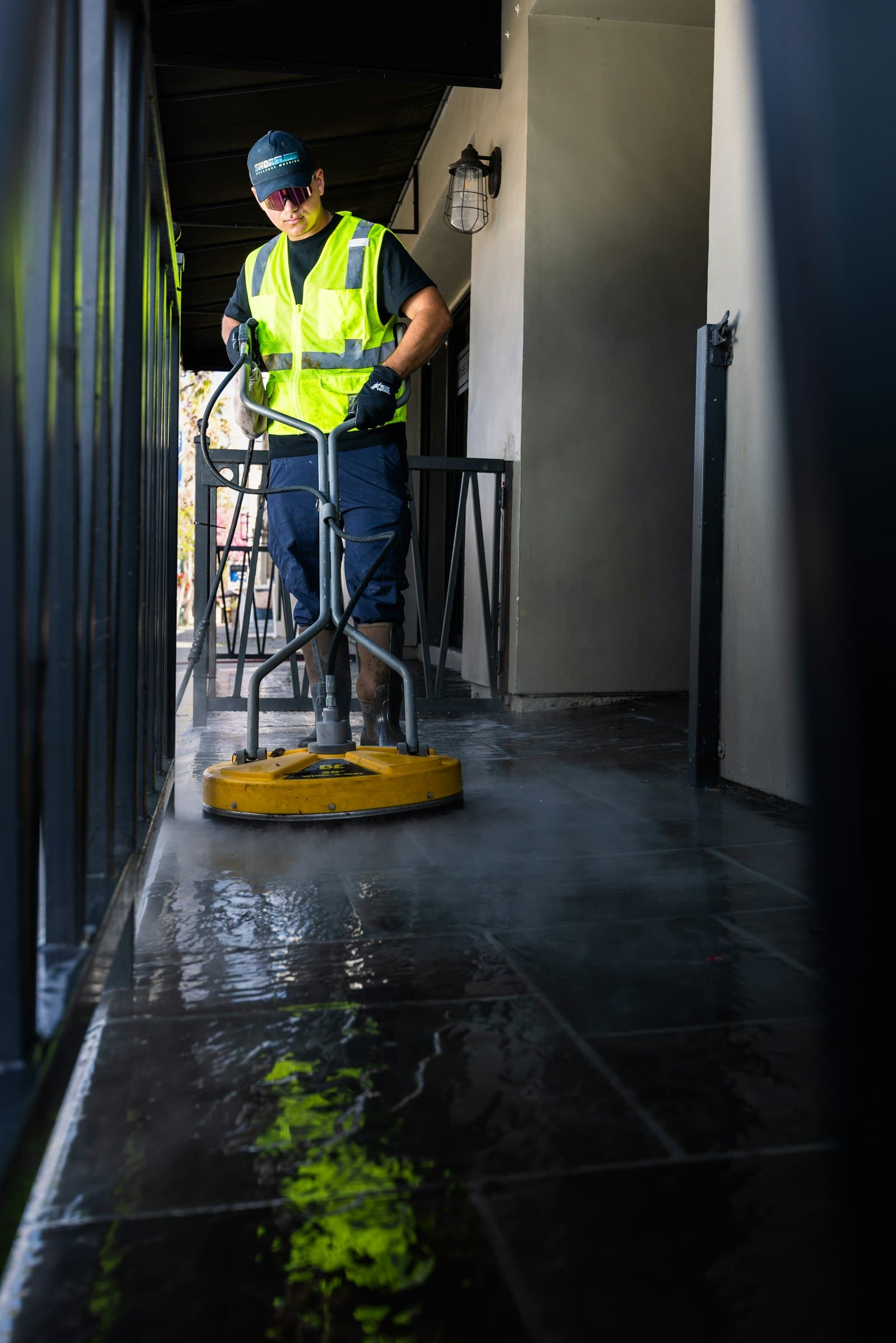 Operative using a rotary floor machine on a dark polished floor