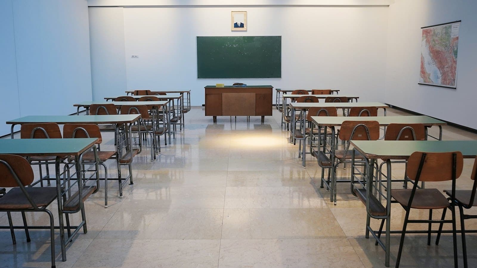 Empty classroom with desks and chairs in rows